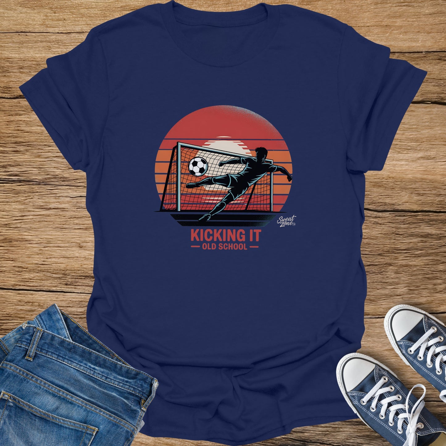 Navy t-shirt with a graphic of a soccer player kicking a ball into a net.
