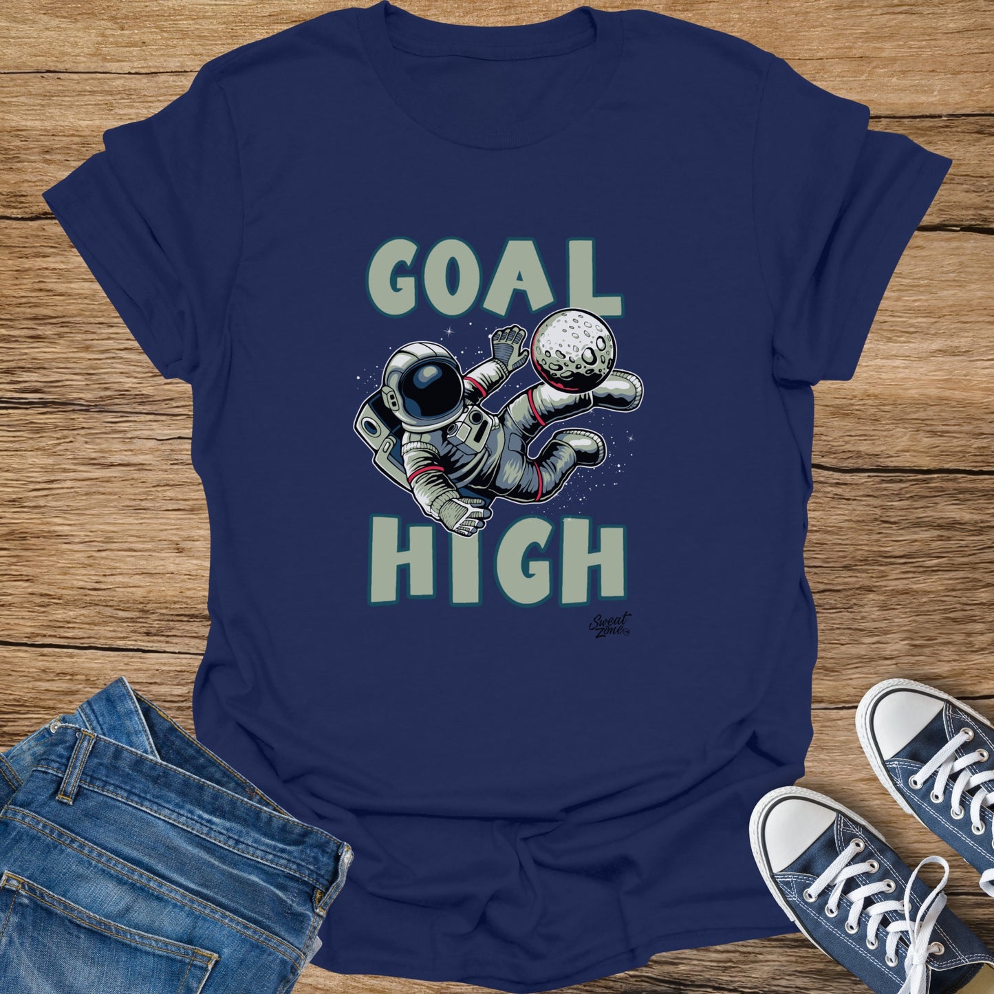 Astronaut kicking a moon with text "GOAL HIGH"