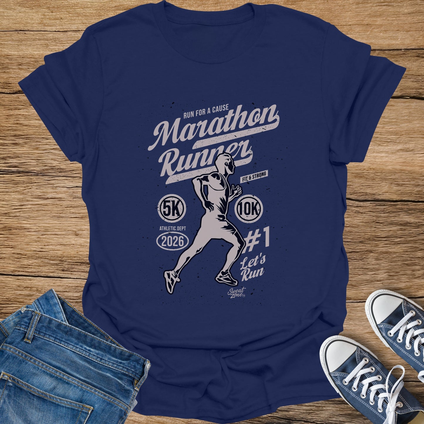 Marathon Runner graphic on navy t-shirt with text "Run for a Cause," "Fit & Strong," "5K," "10K," "2026," and "#1 Let's Run."