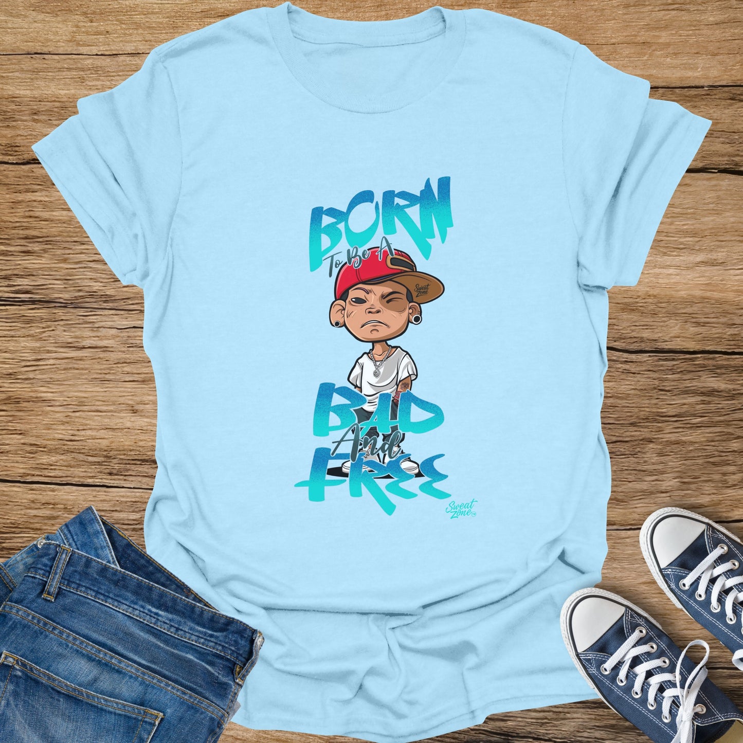 Light blue t-shirt with cartoon boy graphic and text "BORN TO BE A BAD AND FREE".