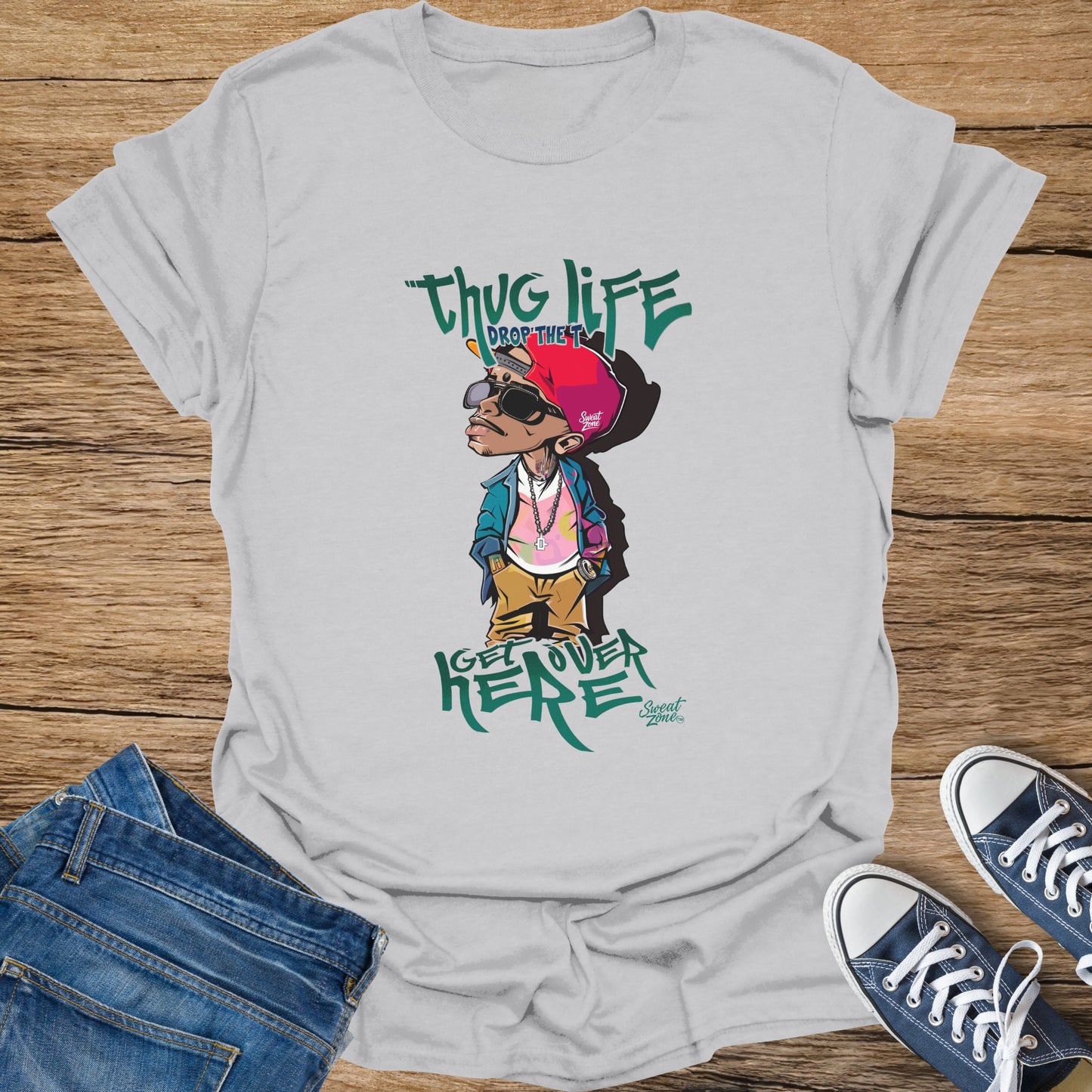 White t-shirt with cartoon of man wearing red hat, sunglasses, and pink shirt, "thug life" text.