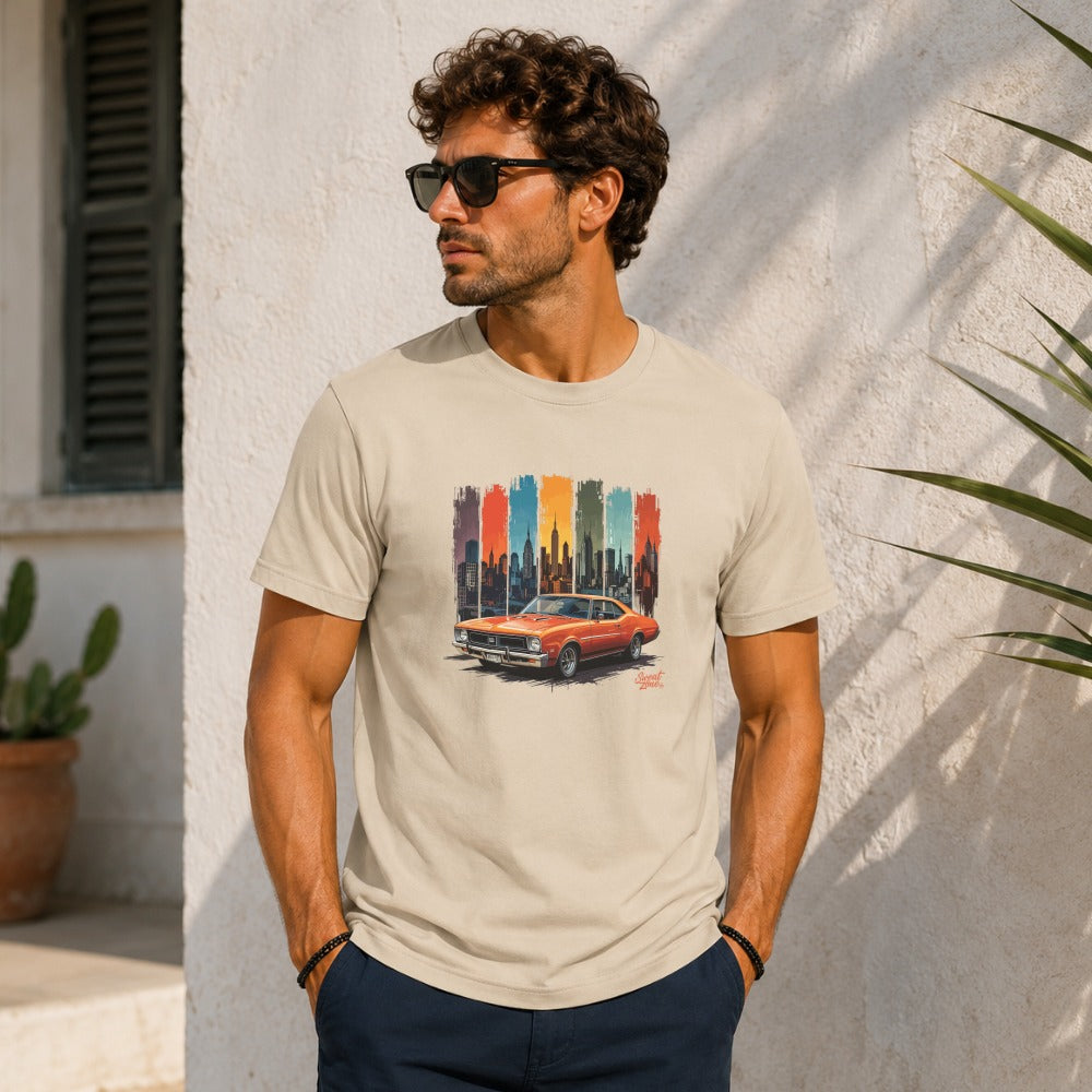 Light tan t-shirt with a graphic of an orange vintage car in front of a cityscape.