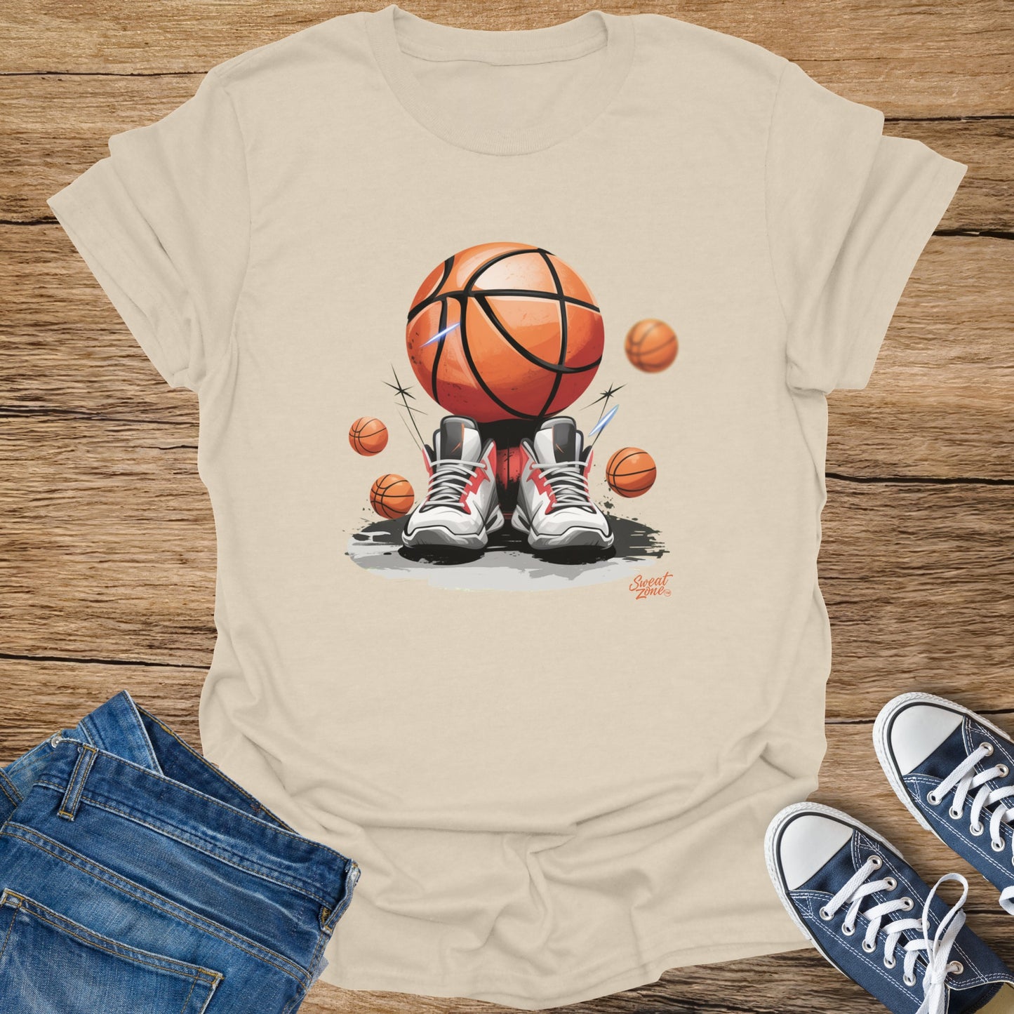 Basketball and sneakers graphic on a cream t-shirt, with jeans and blue shoes.