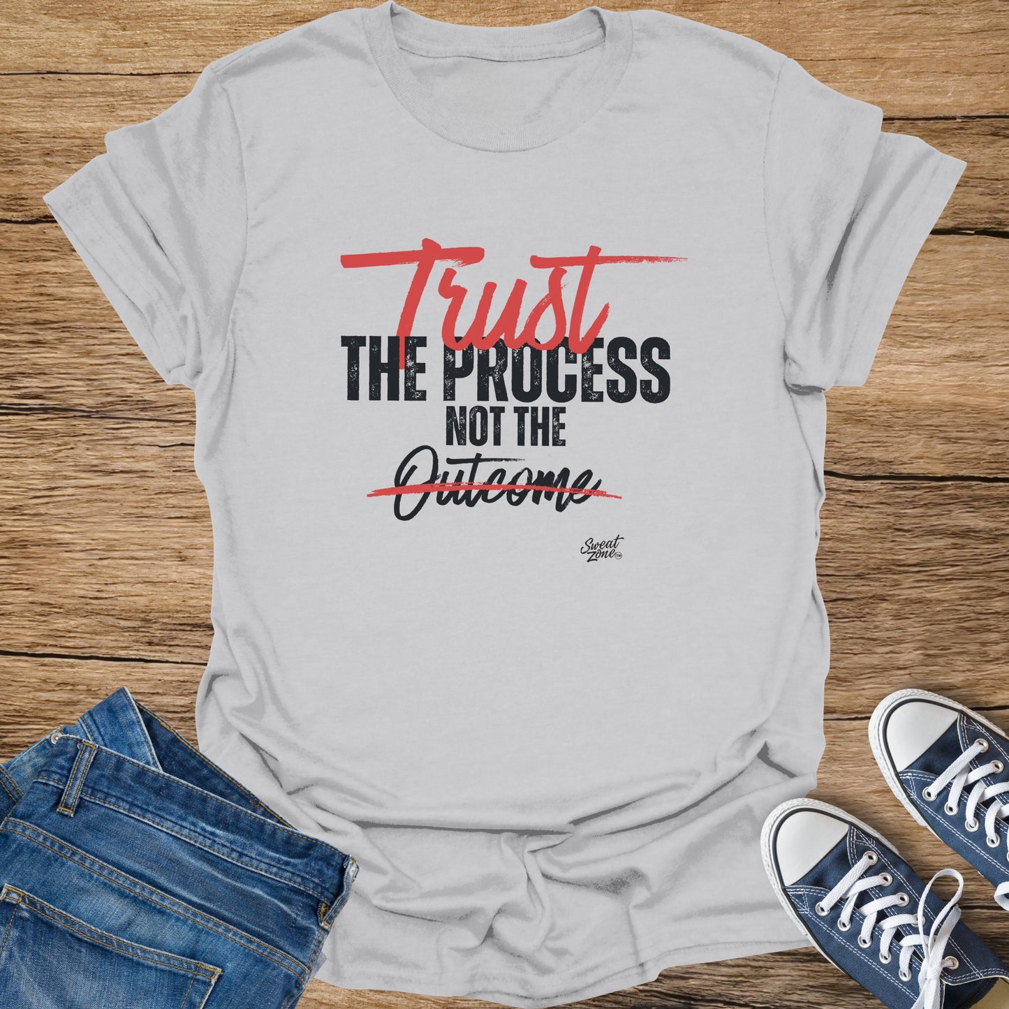 Light grey t-shirt with red and black text reading "Trust THE PROCESS NOT THE Outcome".