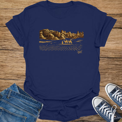 Navy t-shirt with gold desert landscape print and "Sweat Zone" logo.