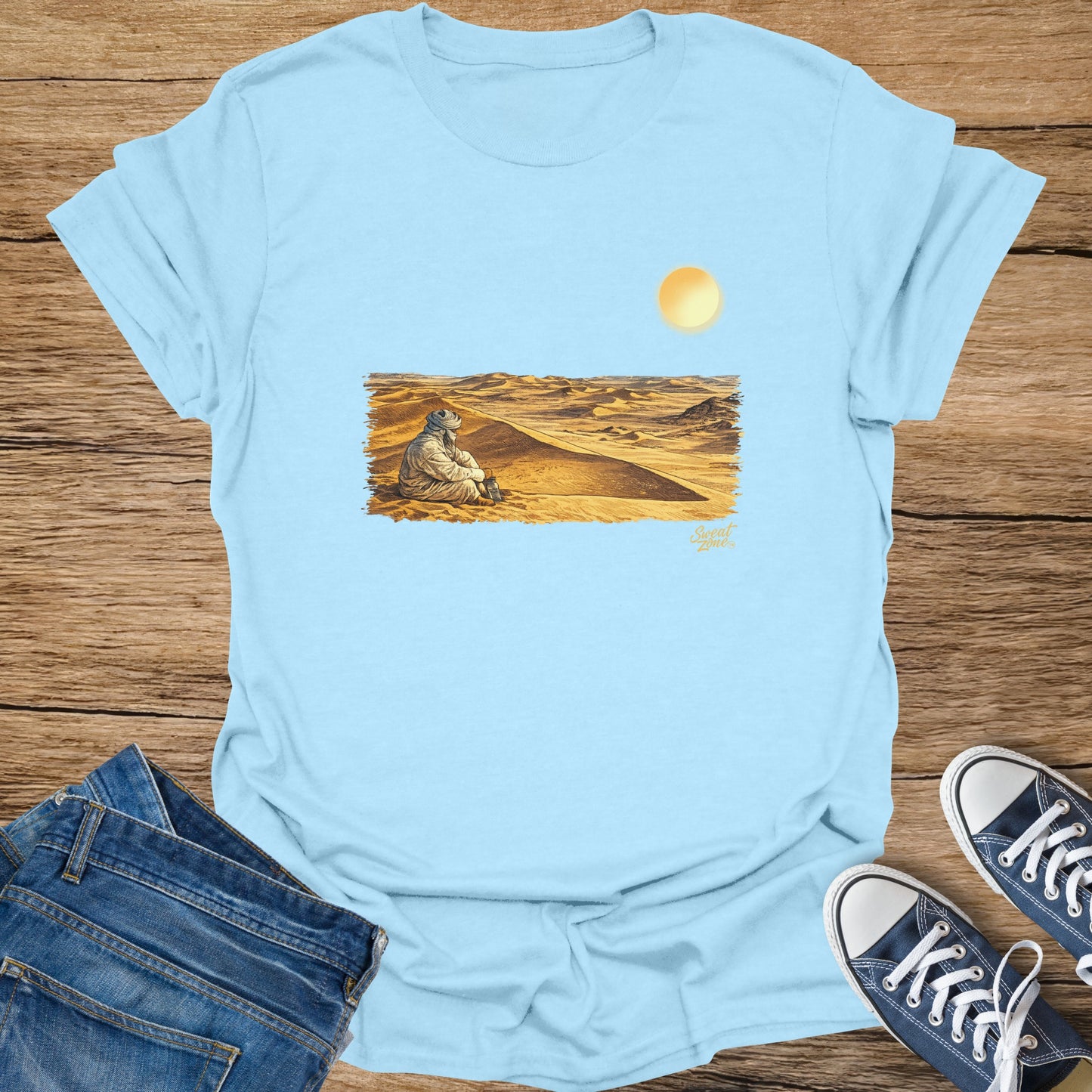 Light blue t-shirt with desert scene art and text "Sweat Zone".