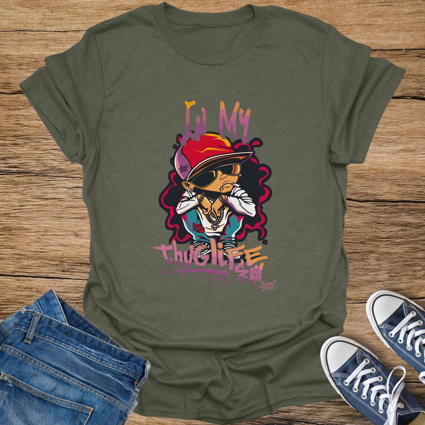 Green t-shirt with cartoon of person in hat and sunglasses, text "IN MY THUG LIFE".