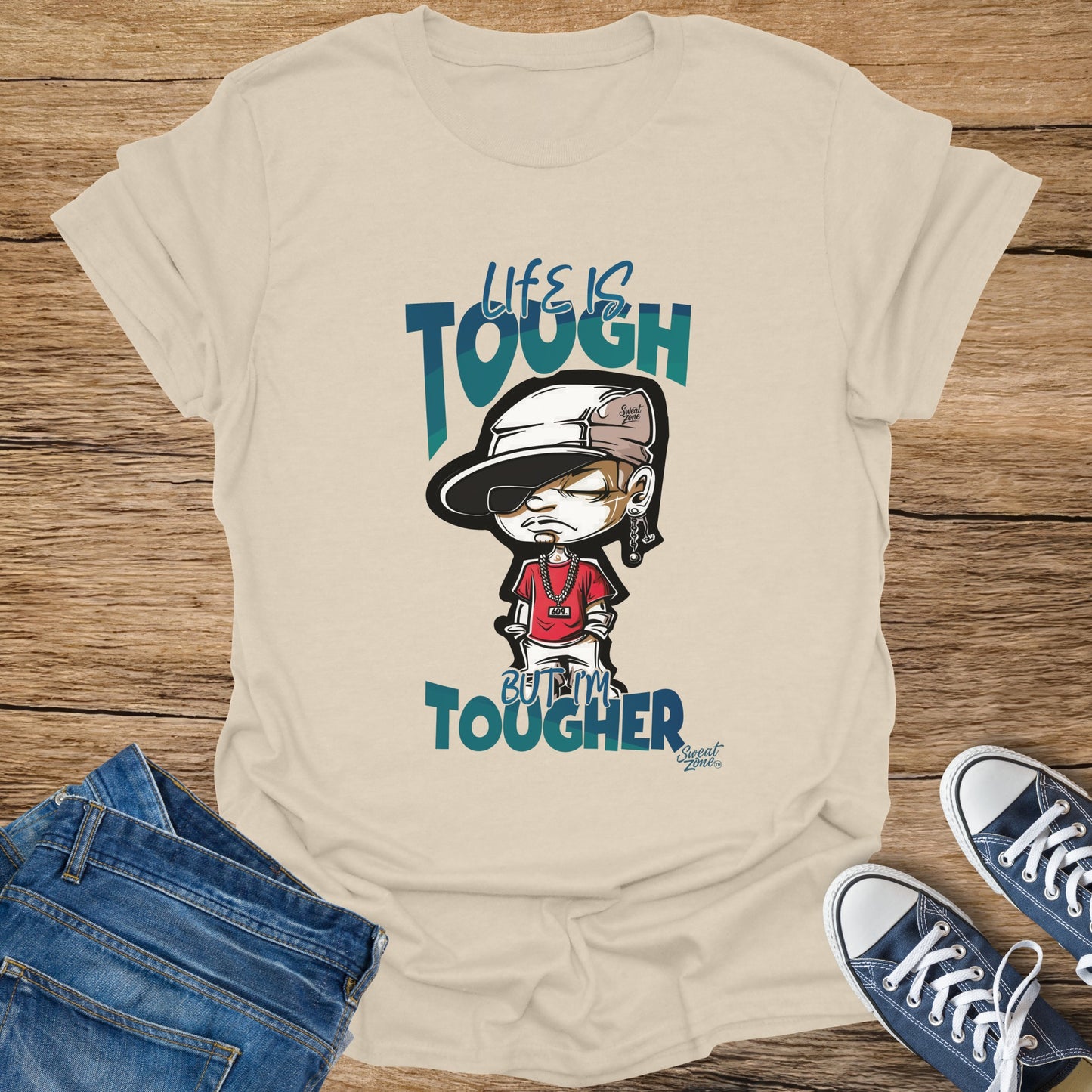 Light beige t-shirt with cartoon man and "Life is Tough But I'm Tougher" text.