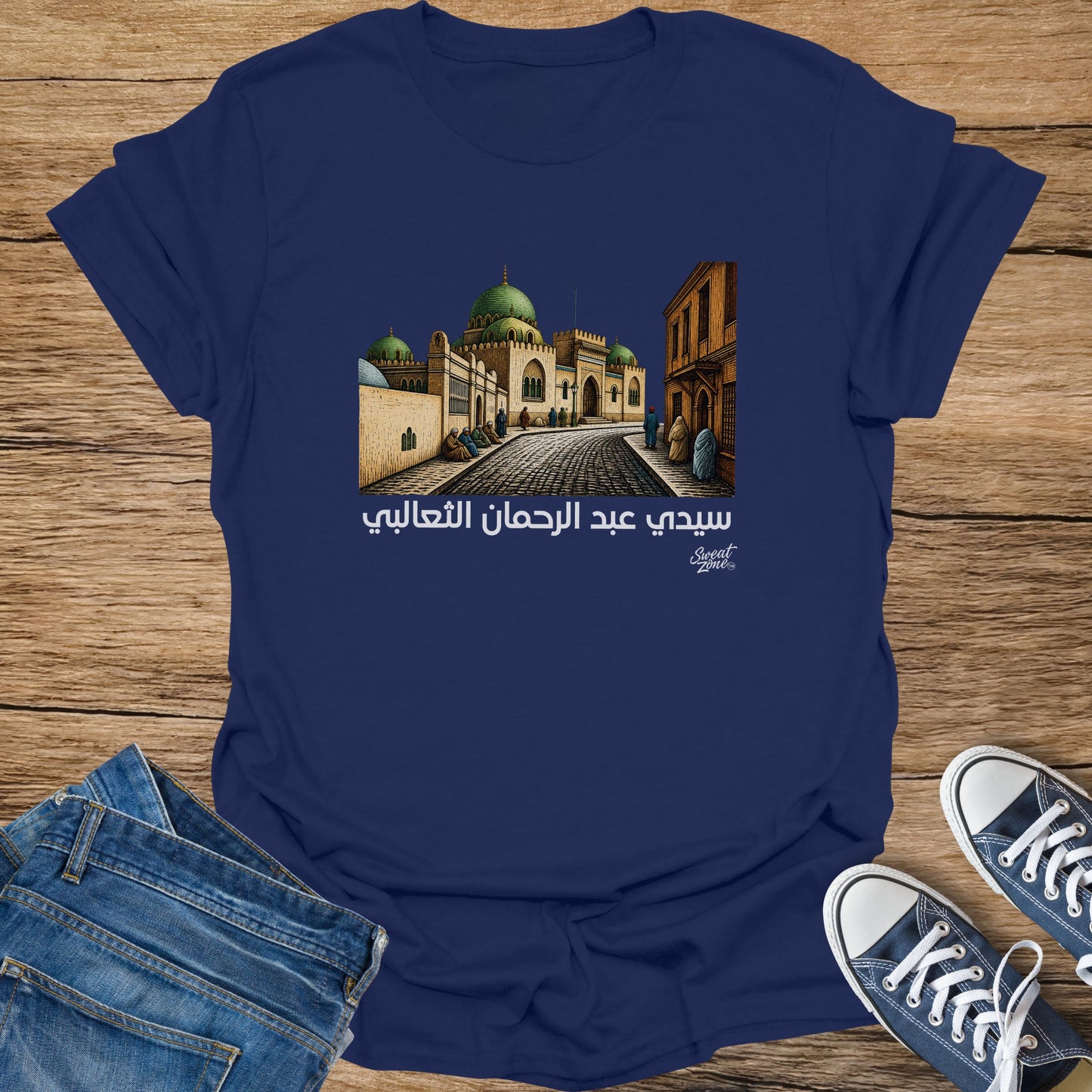 Navy t-shirt with Arabic text and mosque illustration above "Sweat Zone" logo.