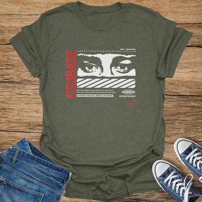 Olive green t-shirt with white and red text and graphic of eyes.