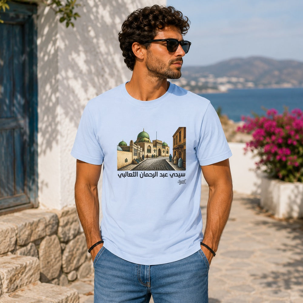 Light blue t-shirt featuring illustration of a mosque and Arabic text.