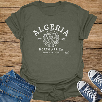 Olive green t-shirt with white "ALGERIA" text, crest, and coordinates.