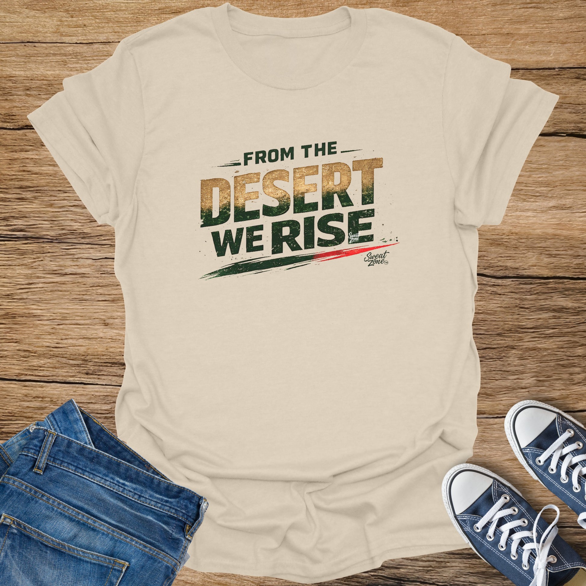 Cream t-shirt with "FROM THE DESERT WE RISE" text, laid flat with jeans and sneakers.