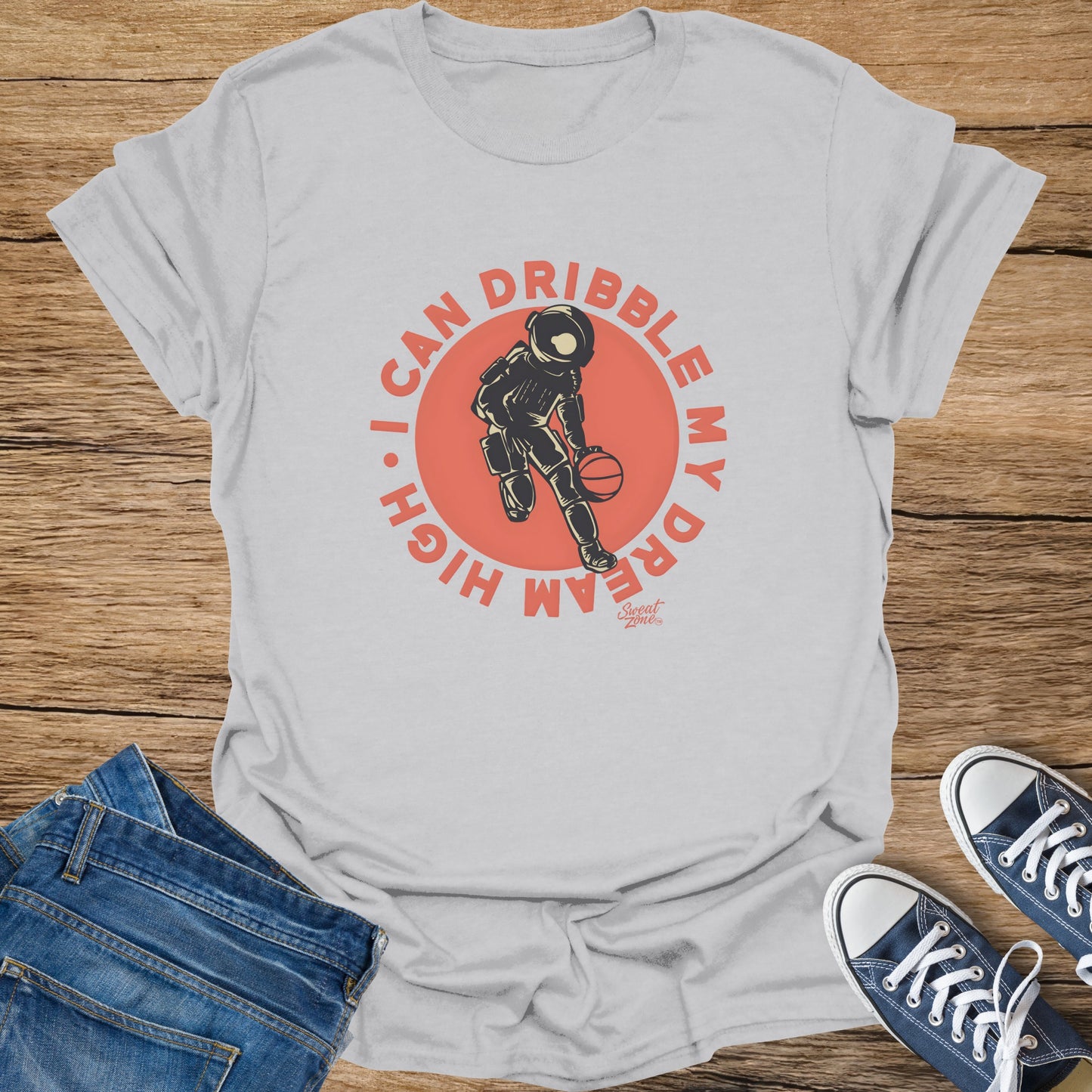 T-shirt with astronaut dribbling a basketball and text "I CAN DRIBBLE MY DREAM HIGH".