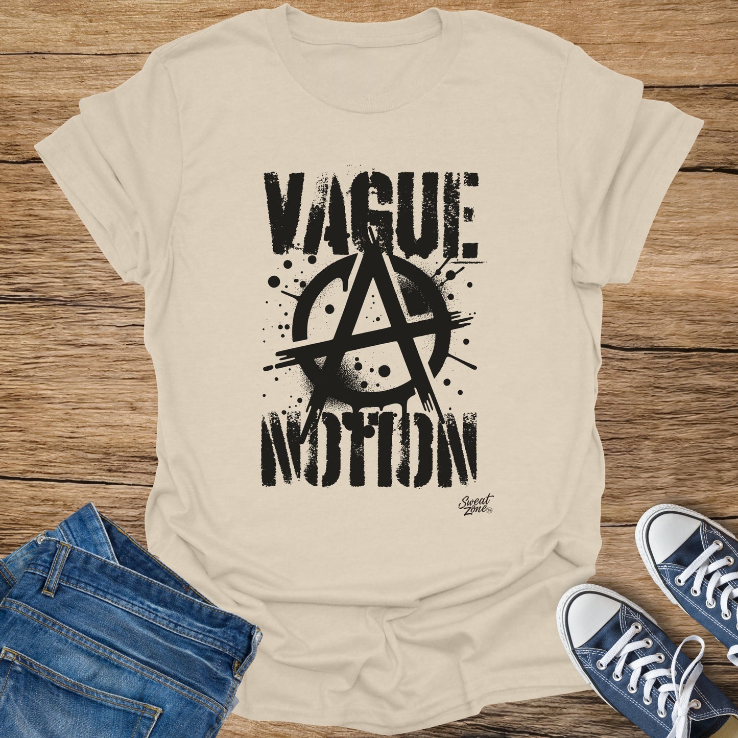 Cream t-shirt with black graphic text "VAGUE MOTION" and anarchy symbol.