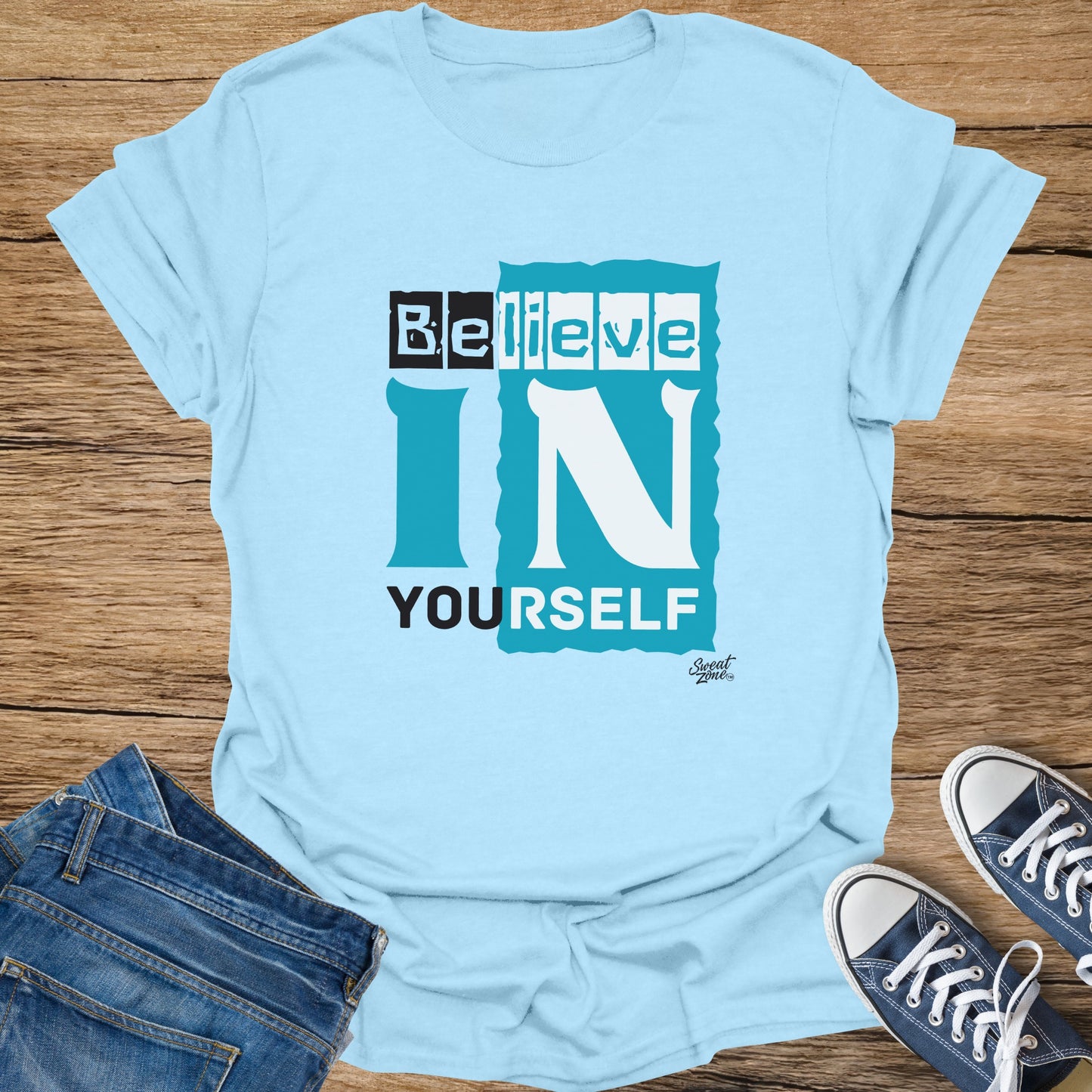 Light blue t-shirt with text "Believe IN YOURSELF" and a small logo.