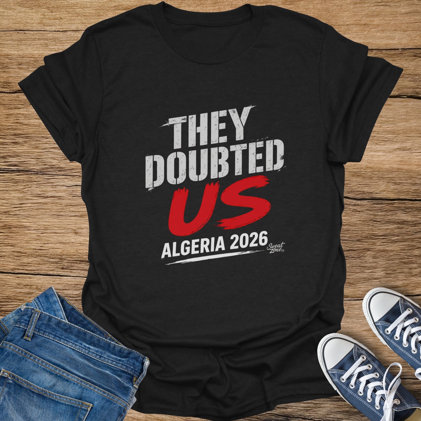 Black t-shirt with white text "THEY DOUBTED US ALGERIA 2026".
