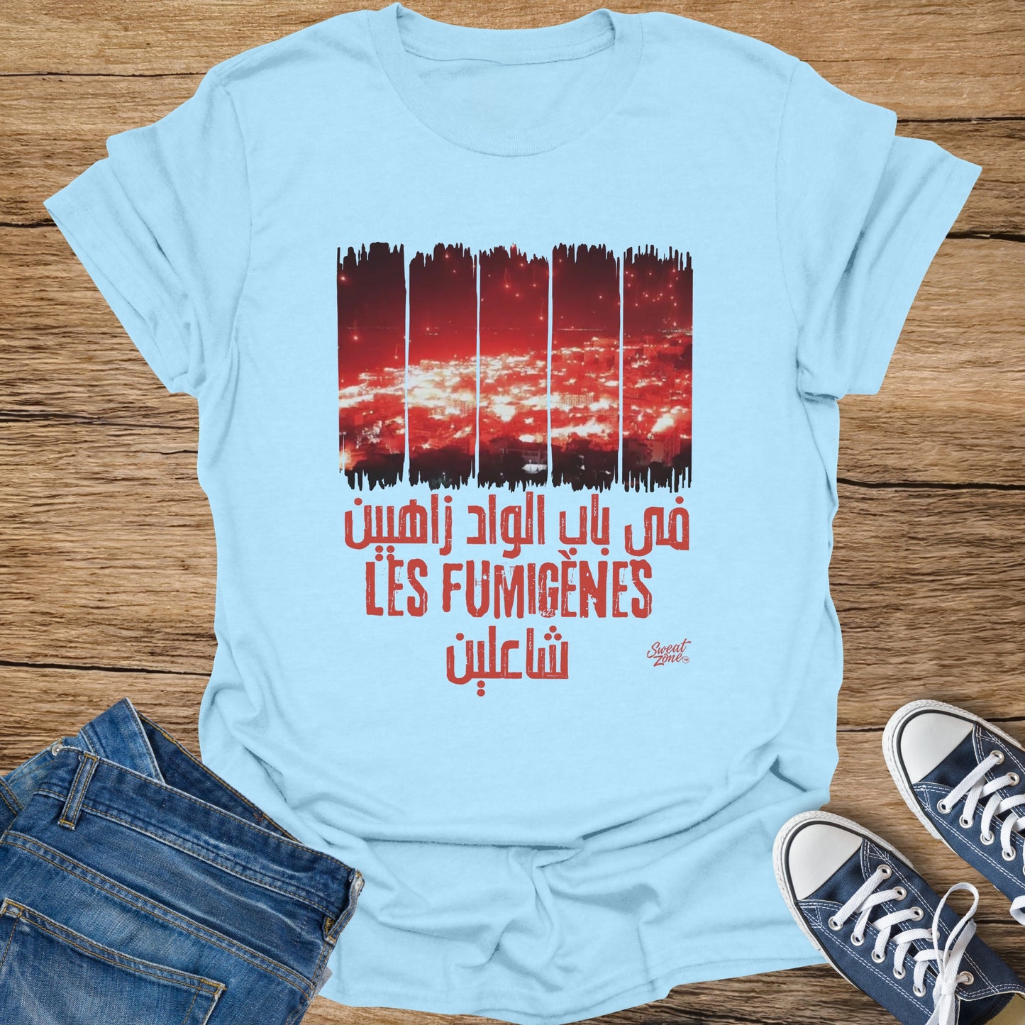 Light blue t-shirt with red graphic text and imagery of city lights.