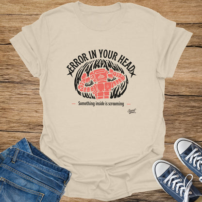 Light beige t-shirt with coral robot graphic and text "Error in your head".