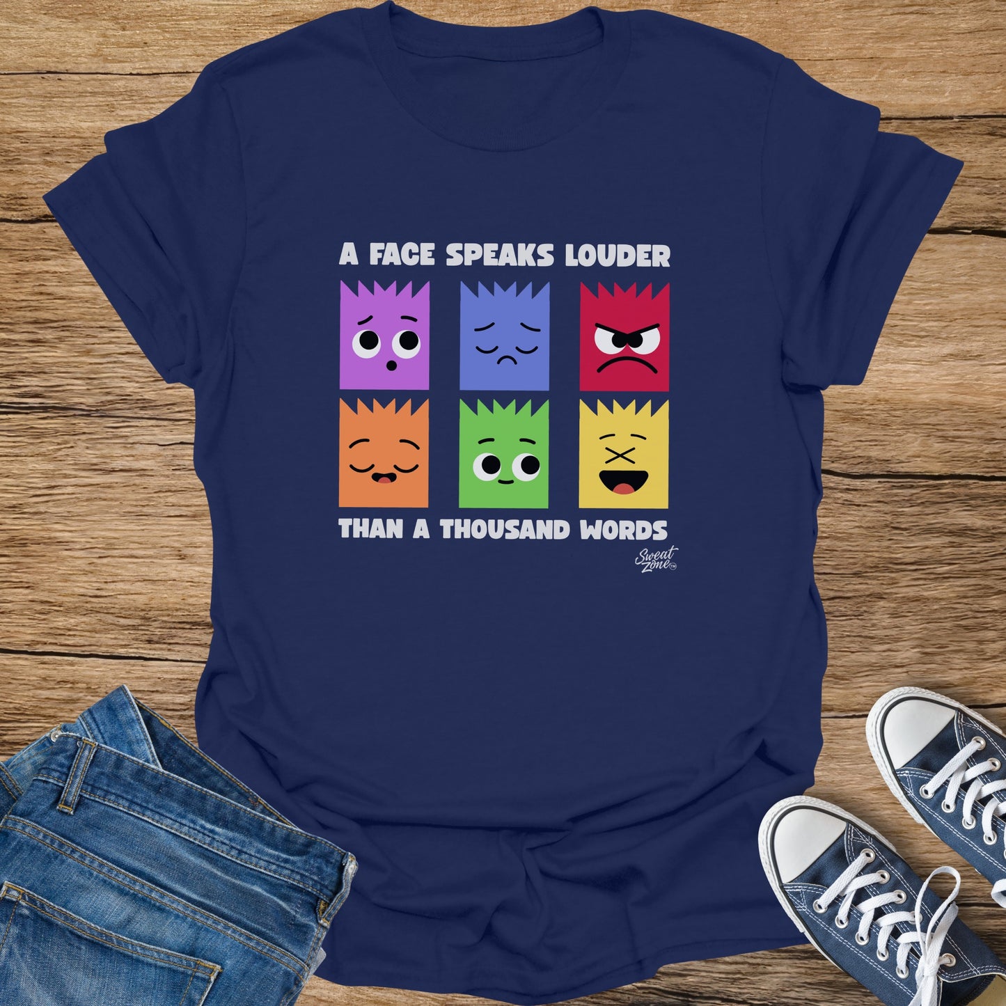 Navy t-shirt with six colorful faces and text "A FACE SPEAKS LOUDER THAN A THOUSAND WORDS."