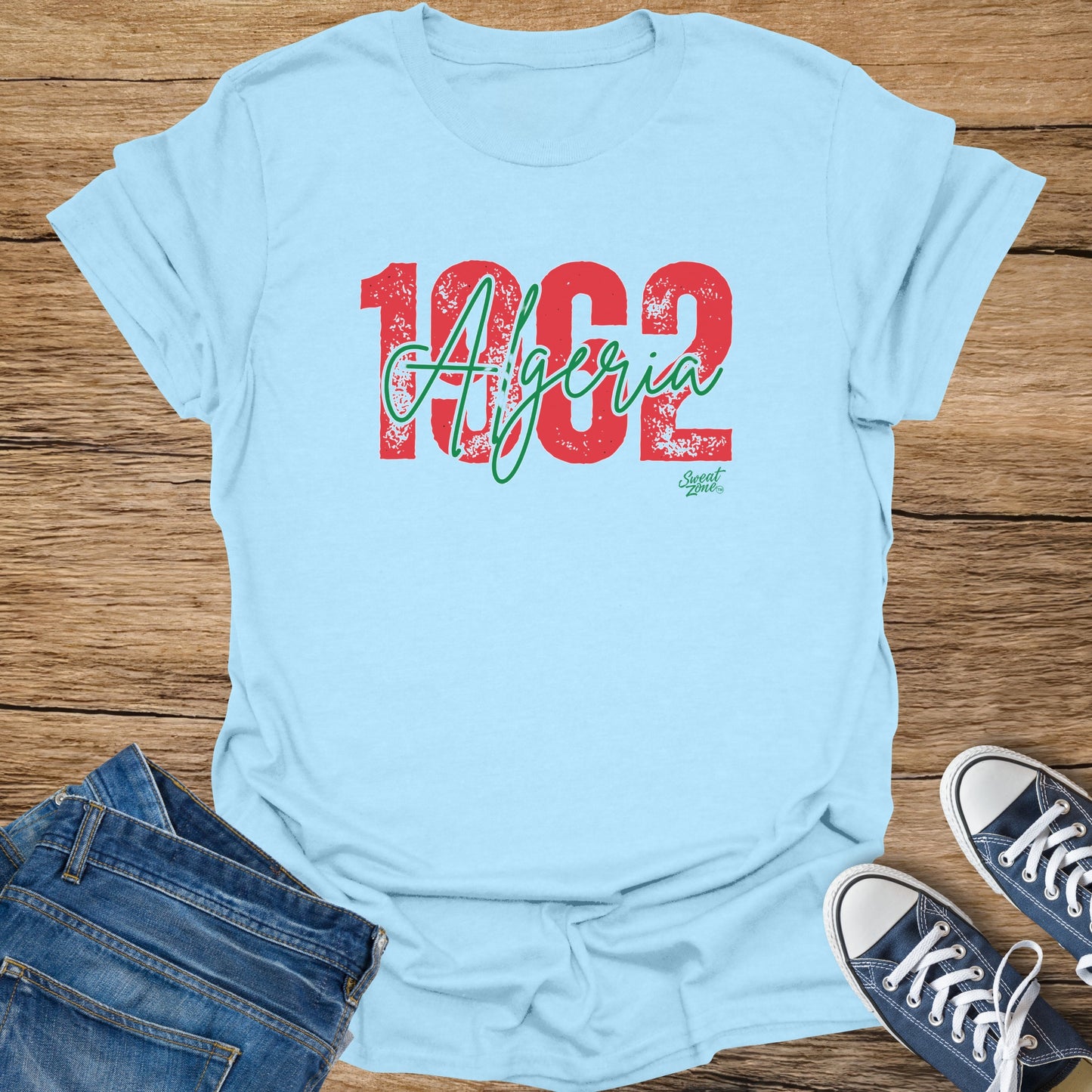 Light blue t-shirt with "1962 Algeria" text in red and green.