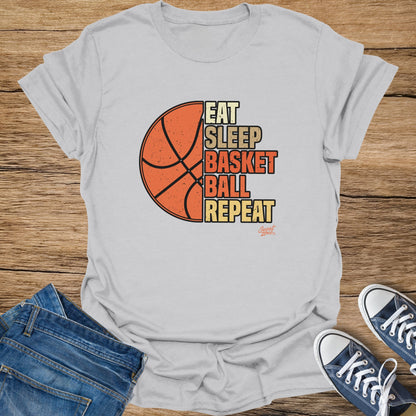 White t-shirt with "Eat Sleep Basketball Repeat" text and a basketball graphic.