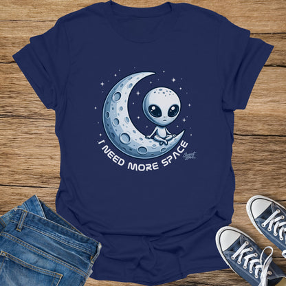 Navy t-shirt with alien sitting on crescent moon saying "I need more space".