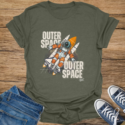 Astronaut and rockets graphic with "Outer Space" text on a green t-shirt.