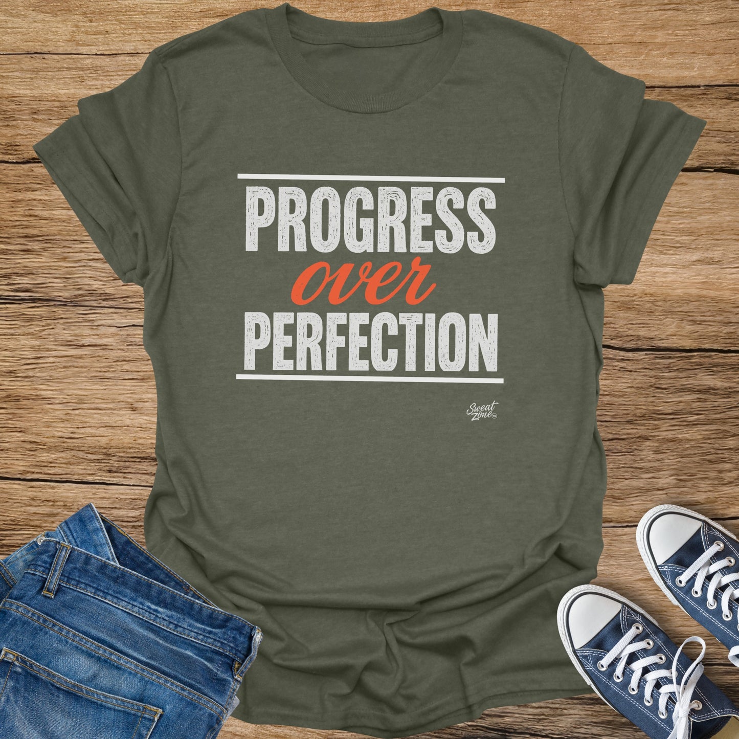 Olive green t-shirt with "PROGRESS over PERFECTION" text and Sweat Zone logo.