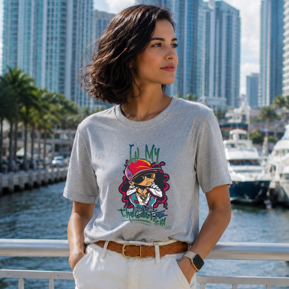 Woman wearing a grey t-shirt with cartoon graphic and text "In My Thuglife".