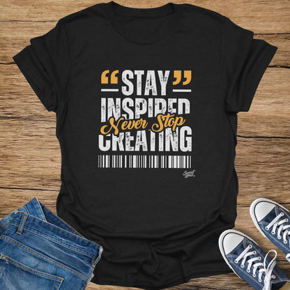 Black t-shirt with "STAY INSPIRED Never Stop CREATING" text and Sweat Zone logo.