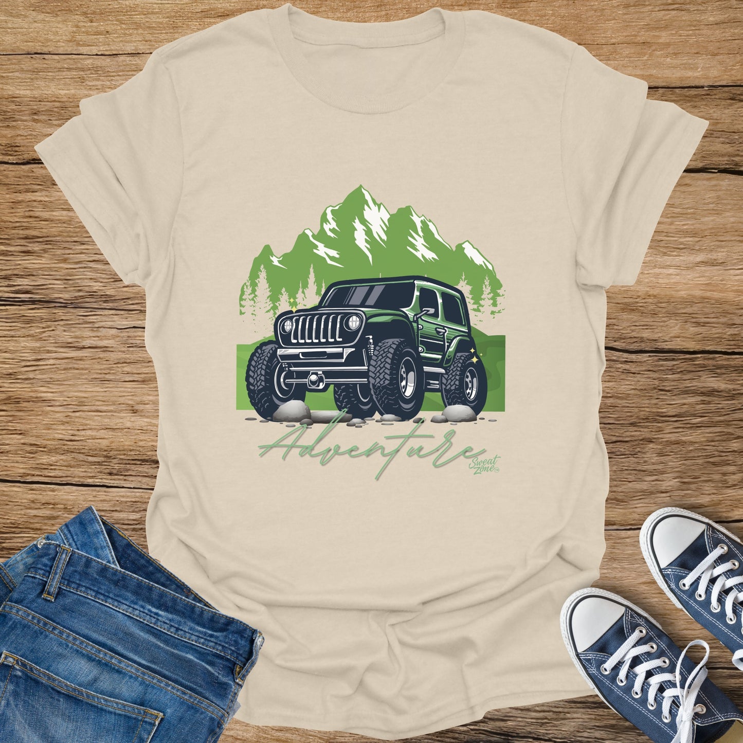 Graphic t-shirt with green off-road jeep, mountains, trees, and text "Adventure".