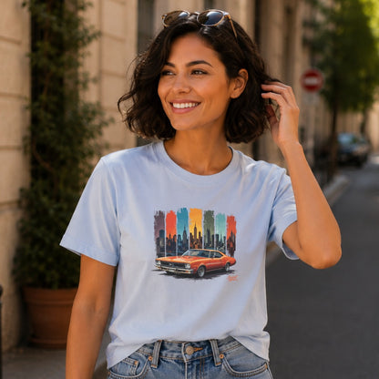 Light blue t-shirt with graphic of orange classic car against colorful watercolor New York City skyline.