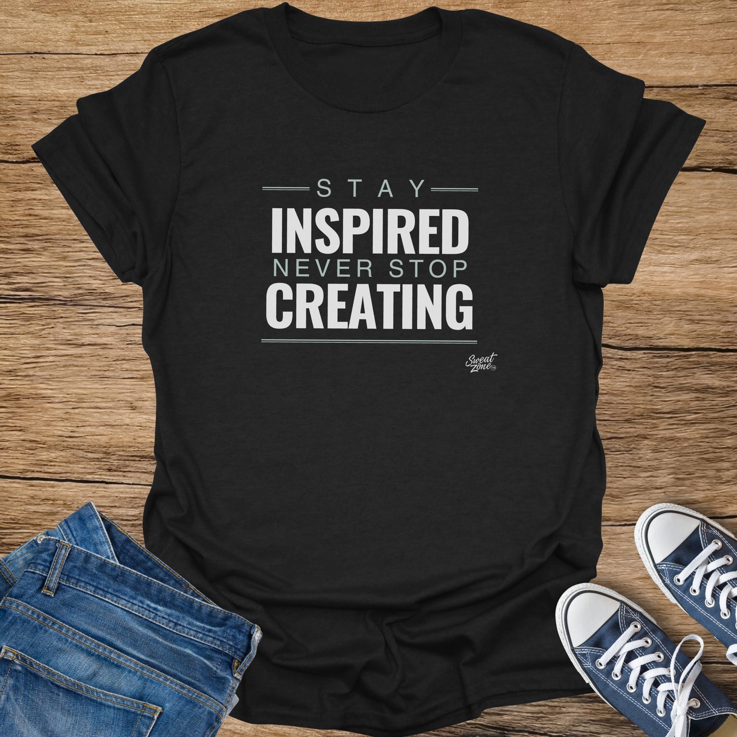 Black t-shirt with "Stay Inspired Never Stop Creating" text and "Sweat Zone" logo.
