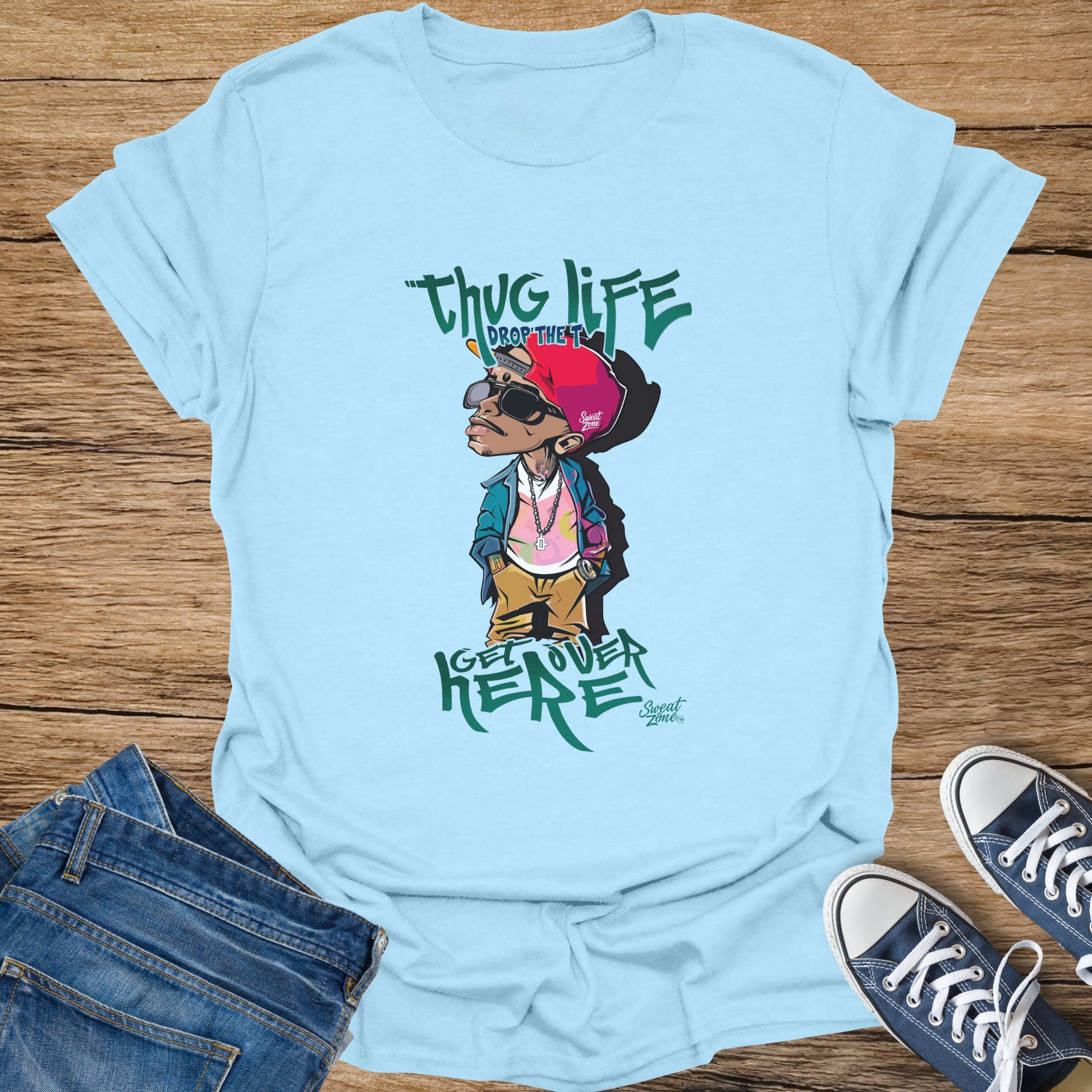 Light blue t-shirt with cartoon character wearing hat and sunglasses, "thug life" text.