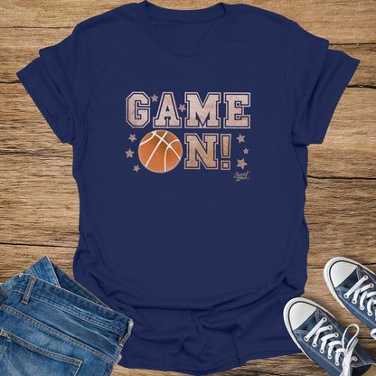 Navy t-shirt with "GAME ON!" text and basketball graphic.
