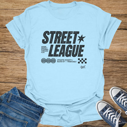 Light blue t-shirt with black "STREET LEAGUE" text, globes, and "Athletic Society" graphic.