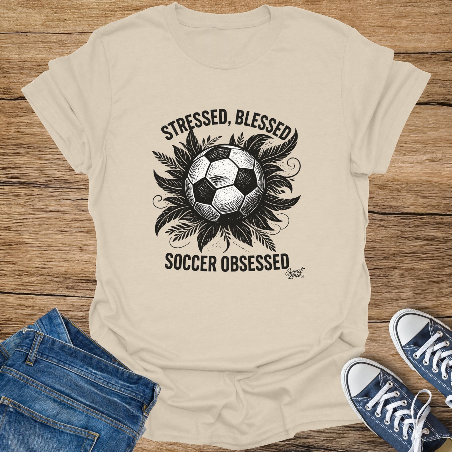 Soccer ball graphic on a tan t-shirt reading "STRESSED, BLESSED SOCCER OBSESSED".