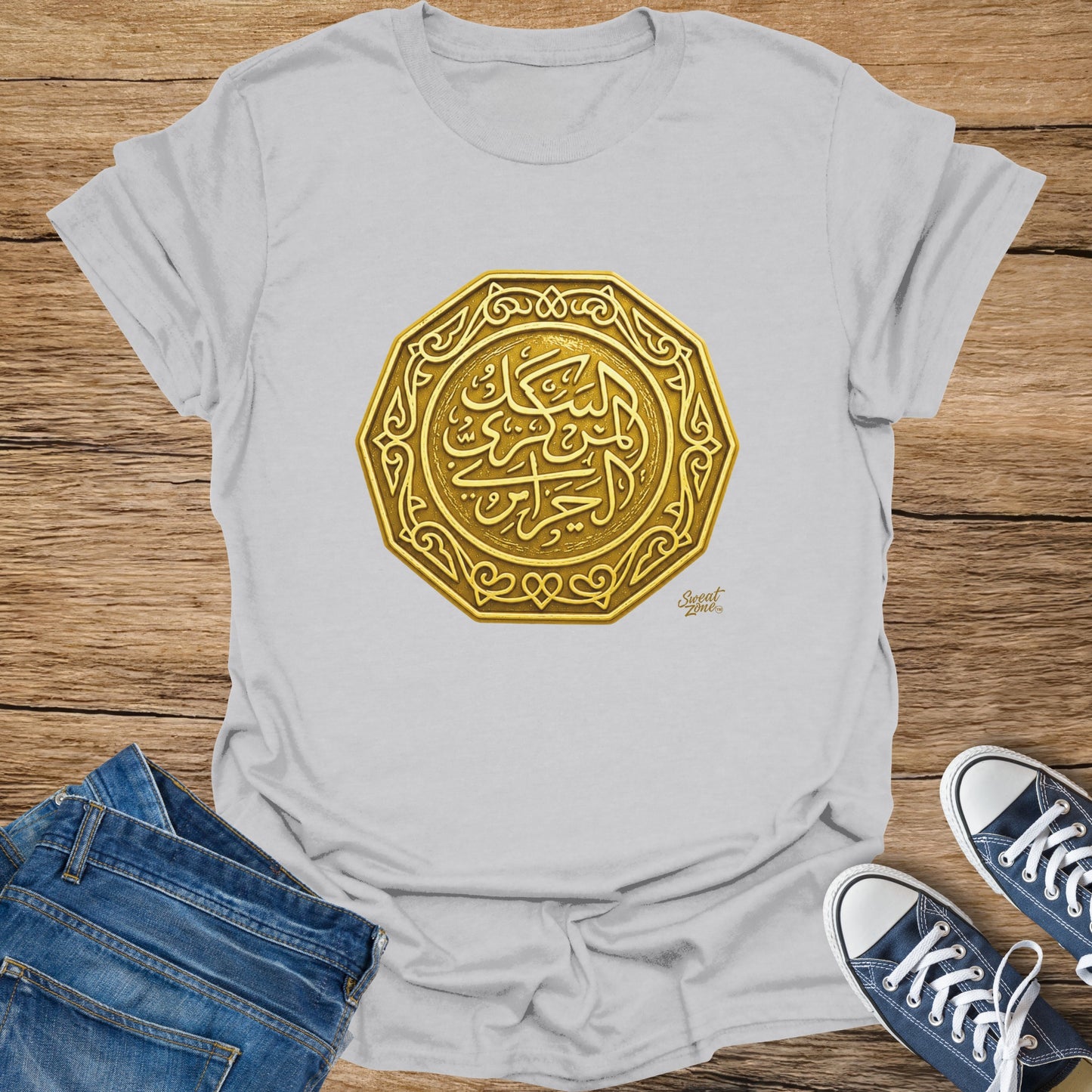 White t-shirt with a 3D gold Arabic calligraphy emblem on the front.