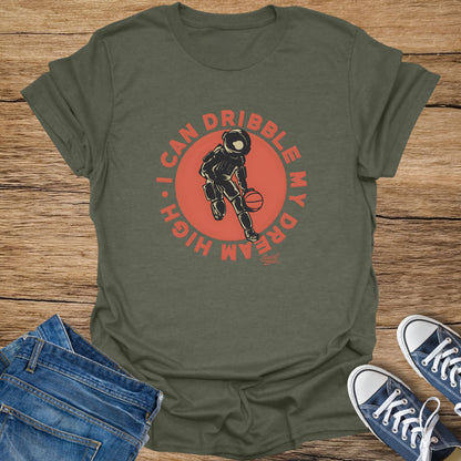Olive t-shirt with astronaut dribbling a basketball and text "I CAN DRIBBLE MY DREAM HIGH".