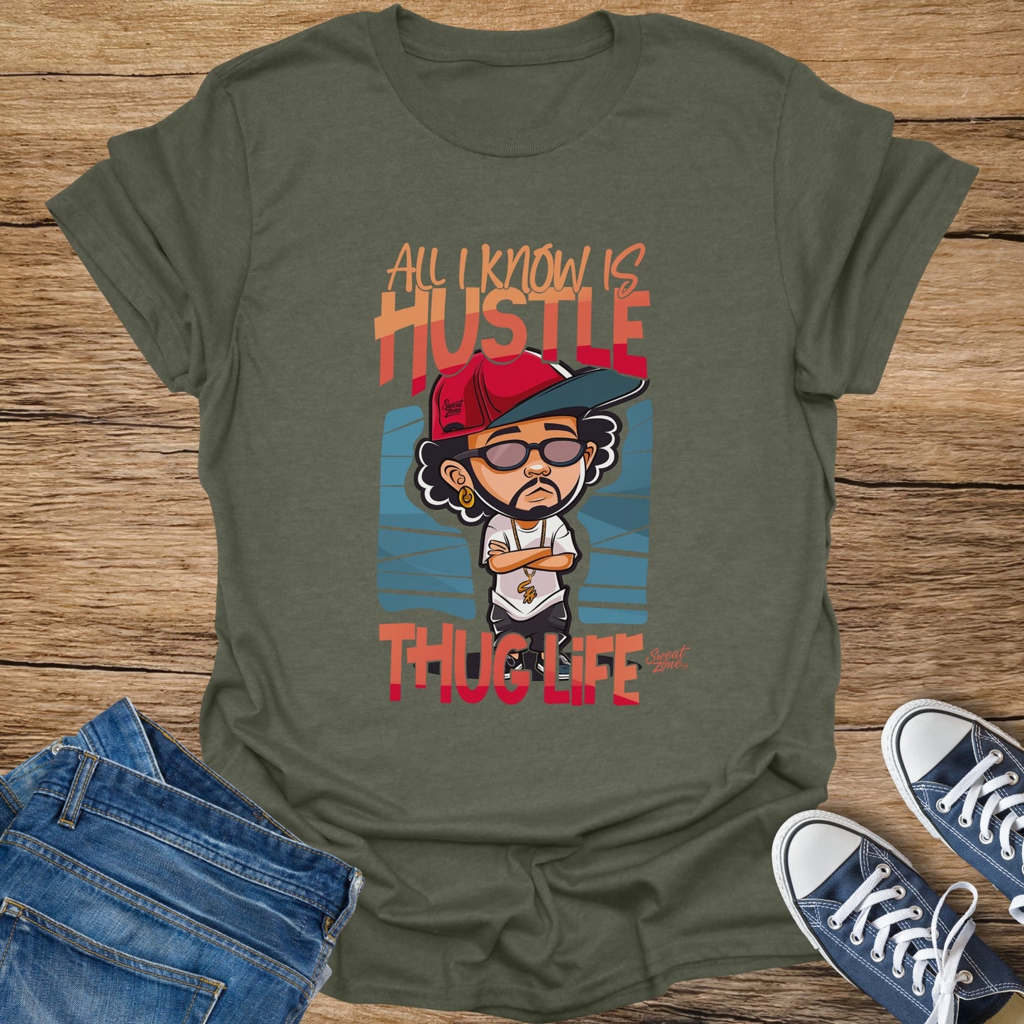 Green t-shirt with cartoon figure and text "All I Know Is Hustle Thug Life".
