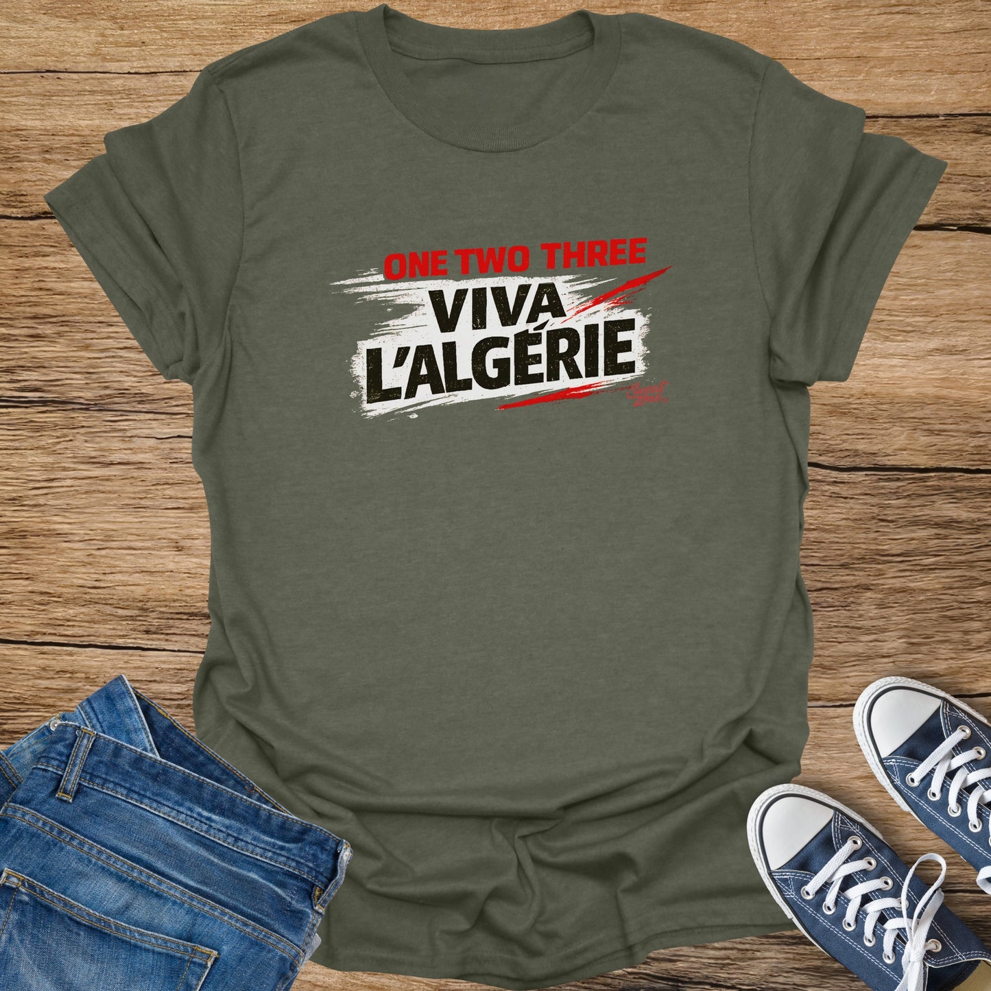 Olive green t-shirt with "ONE TWO THREE VIVA L'ALGERIE" printed in red and white.