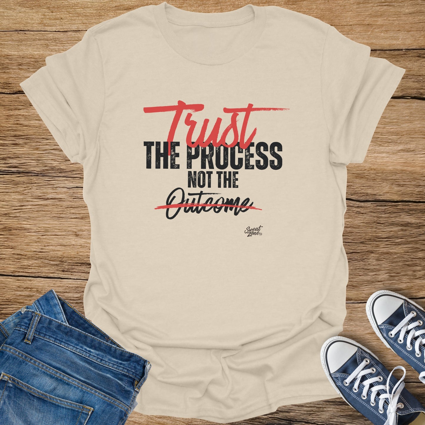 Cream t-shirt with "Trust the Process Not the Outcome" distressed text in black and red.