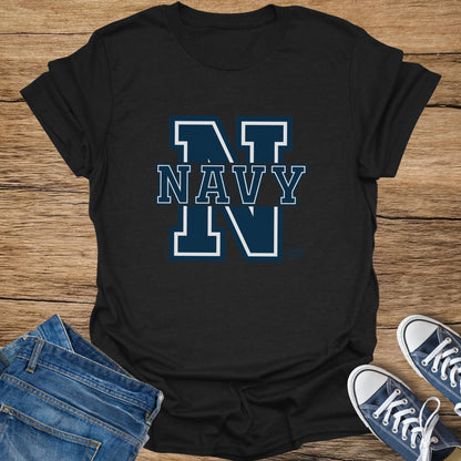 Black t-shirt with "INT NAVY IN" text on a wooden background.