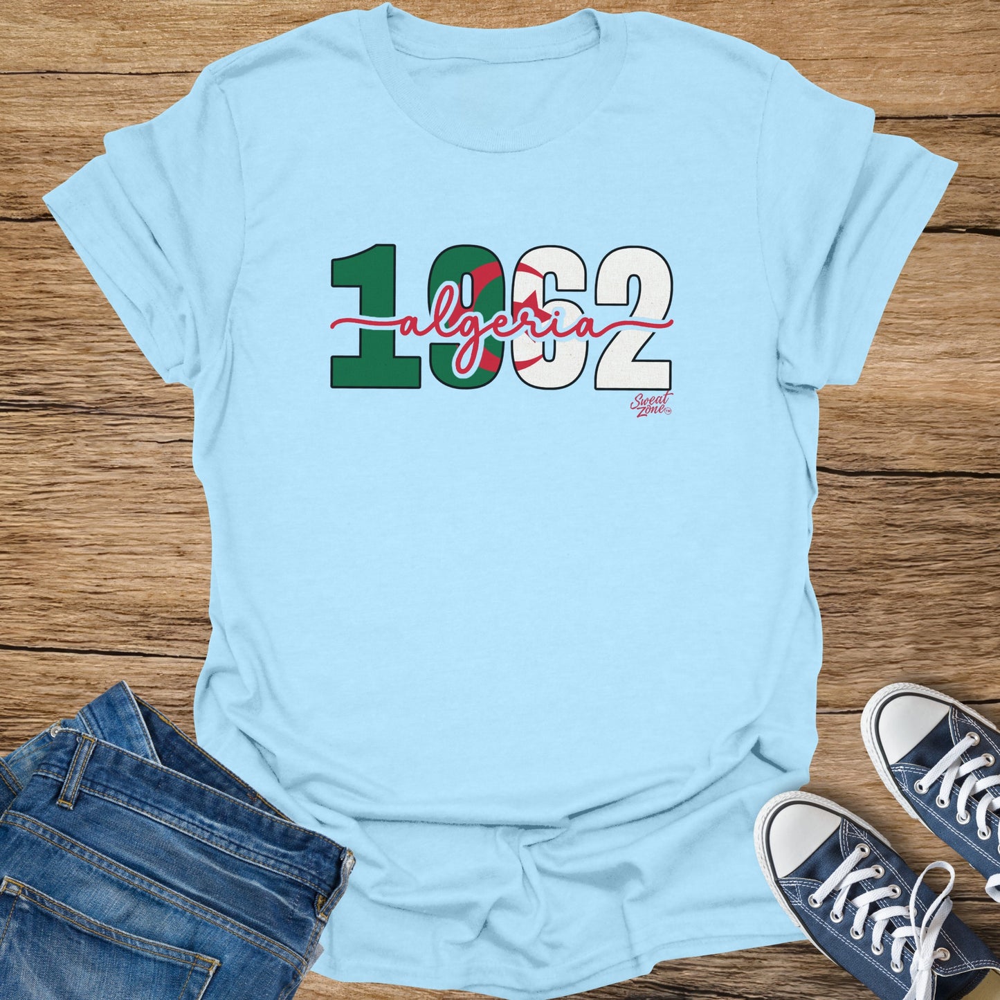Light blue t-shirt with "1962 Algeria" and a small "Sweat Zone" logo.