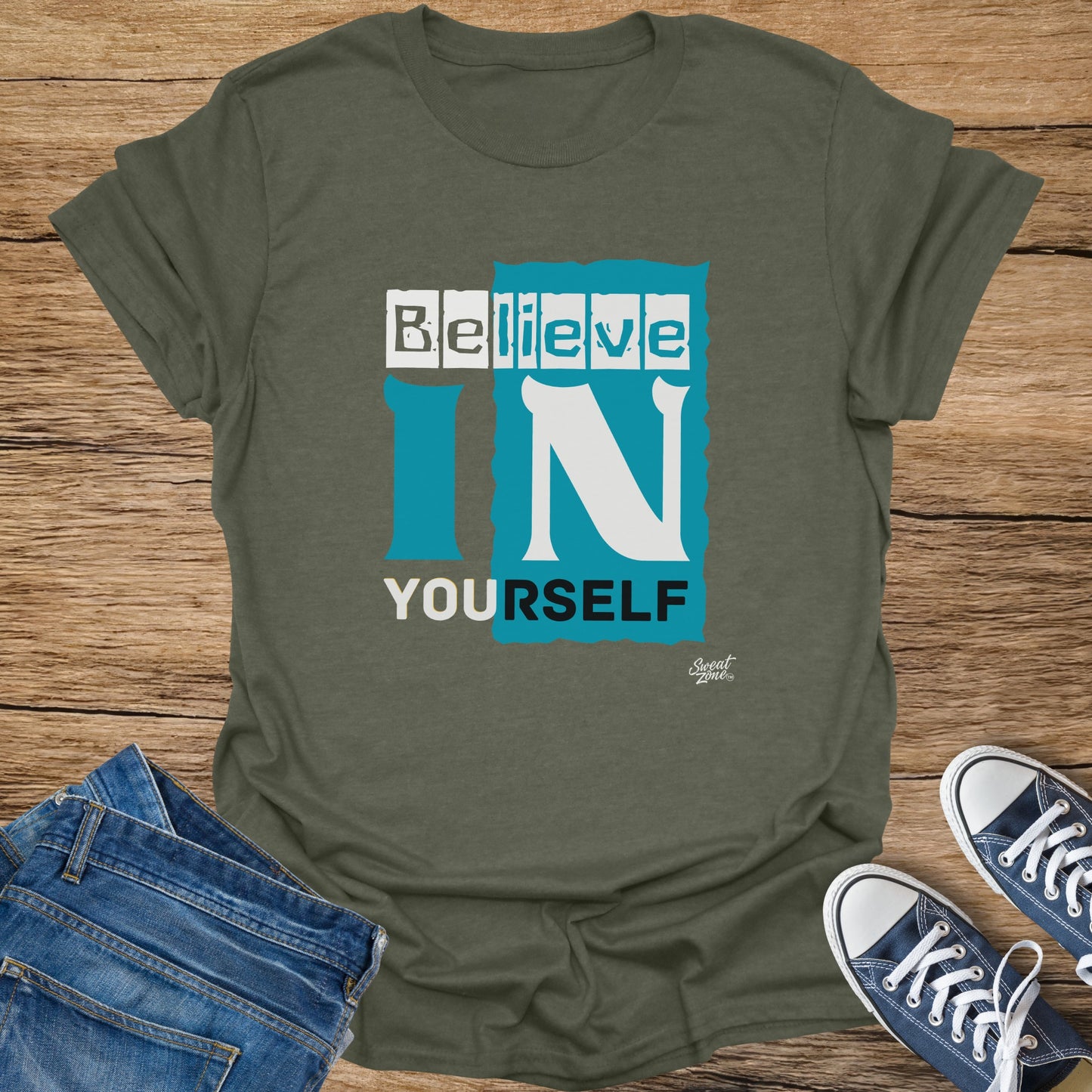 Olive green t-shirt with the words "BELIEVE IN YOURSELF" in white and teal text.