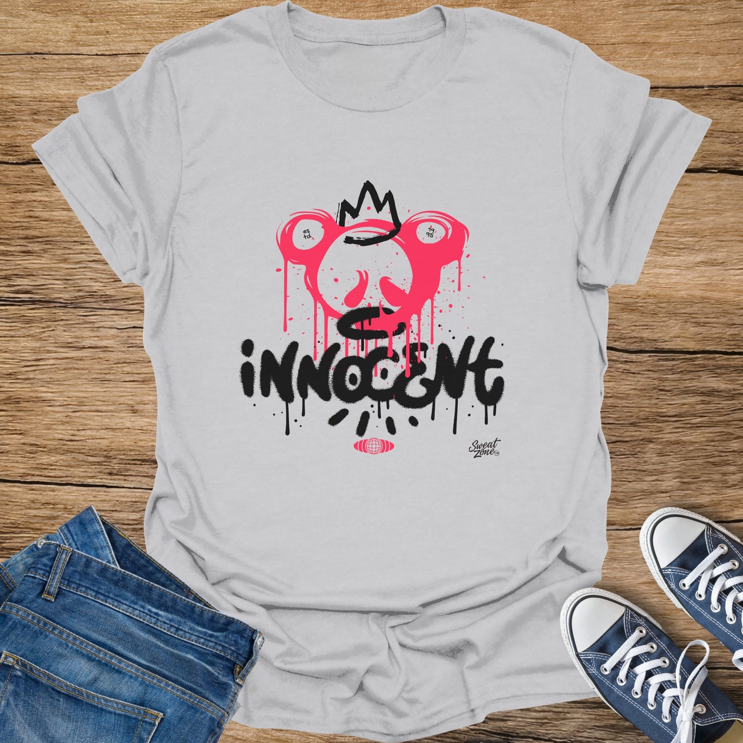 Light grey t-shirt with pink dripping crown design and black "innocent" text.
