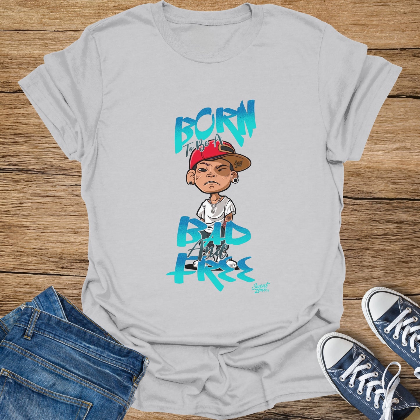 White t-shirt with "BORN TO BE A BAD AND FREE" cartoon graphic and "Sweat Zone" logo.