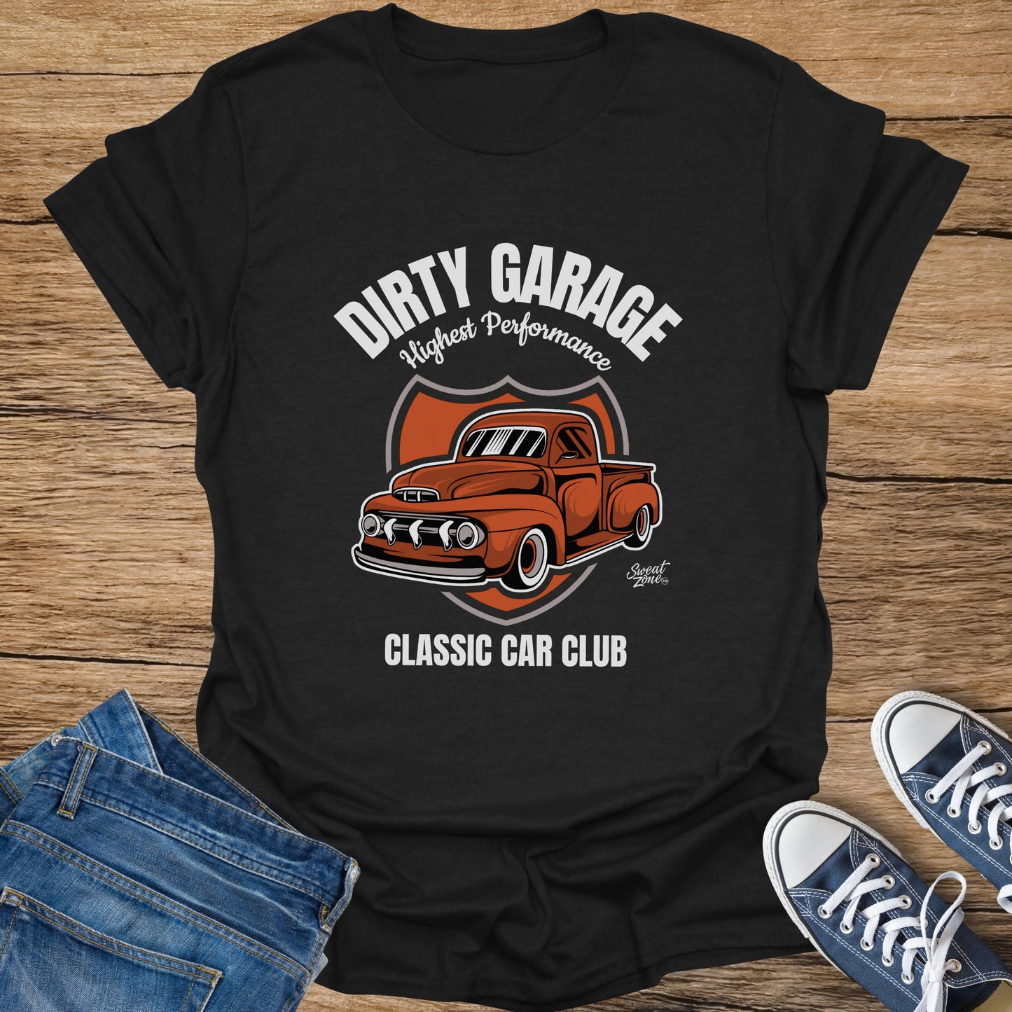 Black t-shirt with orange vintage truck graphic and text: "DIRTY GARAGE HIGHEST PERFORMANCE CLASSIC CAR CLUB"