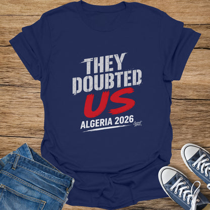 Navy t-shirt with "THEY DOUBTED US ALGERIA 2026" in white and red.